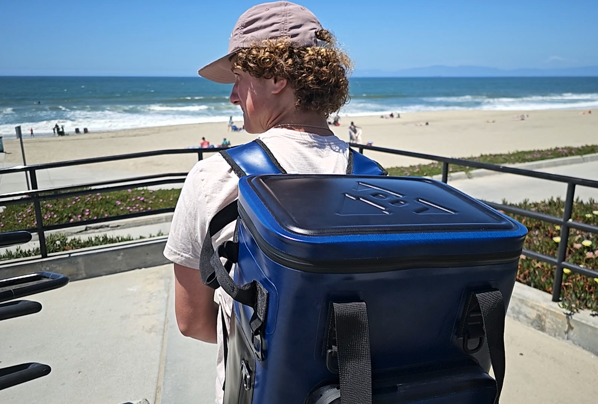 "25-liter insulated backpack cooler in black with multiple pockets for camping and hiking adventures"