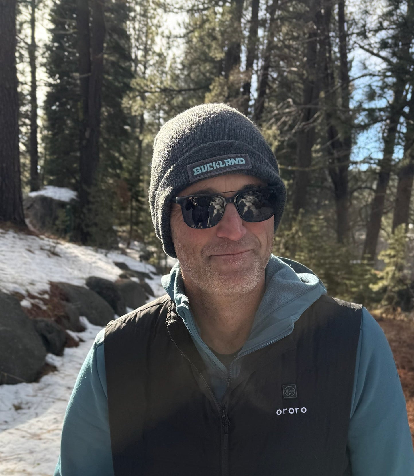 Man wearing a Buckland Beanie in the woods.