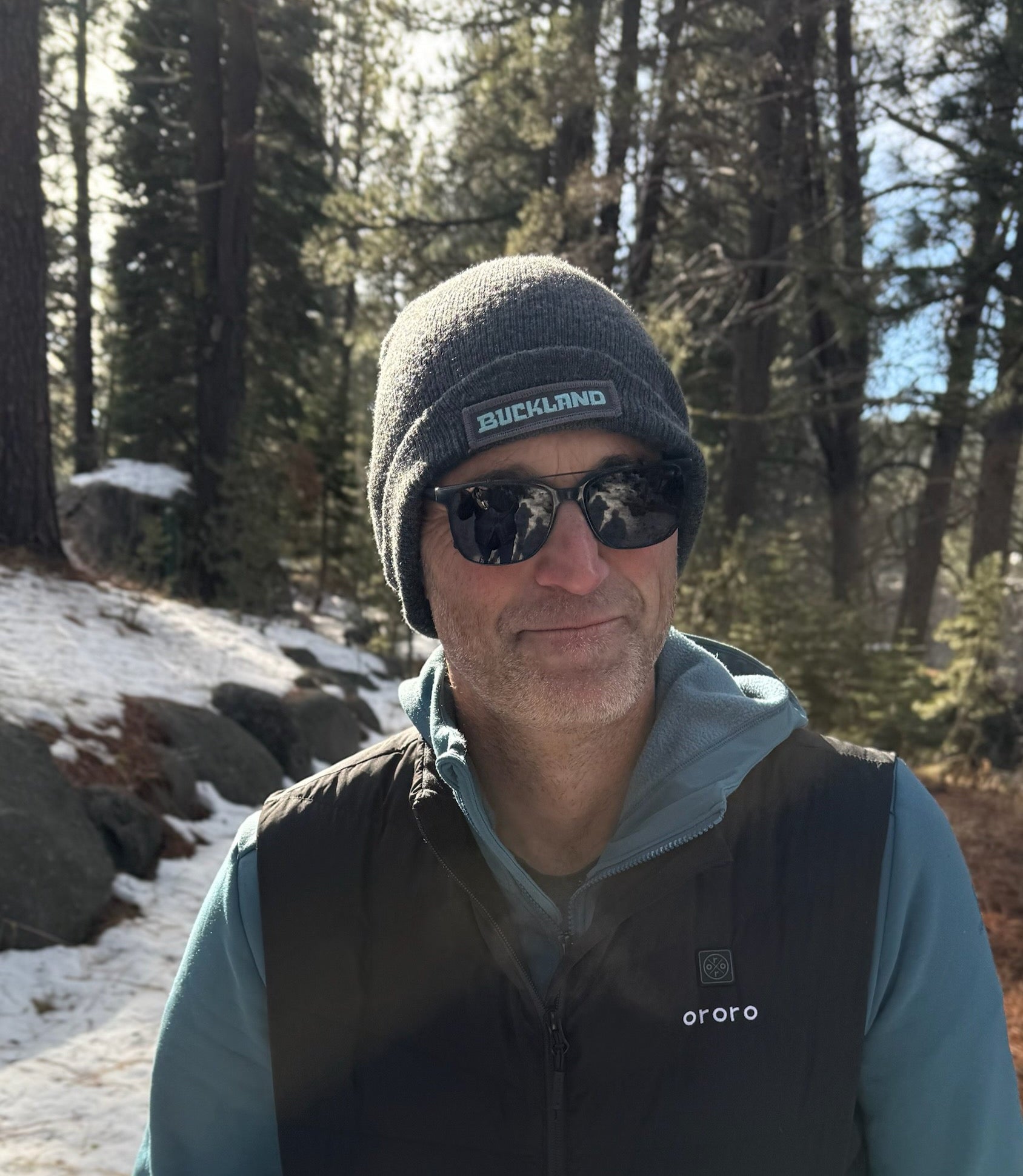 Man wearing a Buckland Beanie in the woods.